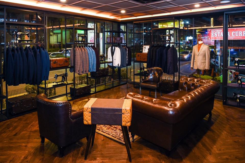 The fitting room with leather sofa and suit racks